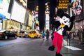 Times Square, New York City, New York, United States - circa 2012 disney mickey mouse character in costume times square at night