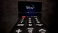 Disney Plus Streaming - Flight over TV Remote control - CITY OF FRANKFURT, GERMANY - MARCH 29, 2021 Royalty Free Stock Photo