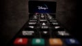 Disney Plus Streaming - Flight over TV Remote control - CITY OF FRANKFURT, GERMANY - MARCH 29, 2021 Royalty Free Stock Photo