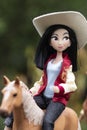 Disney princess doll Mulan walking on a horse