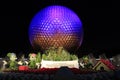 Disney`s EPCOT Center sphere illuminated at night during Holidays Season with Mickey Mouse, Minnie and Pluto characters grass scul
