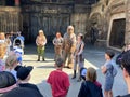 A crowd gather to watch Rey and Chewbacca warn of nearby imperial soldiers