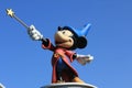 A close-up on the statue of Mickey Mouse in Disneyland Paris, France - isolated blue background