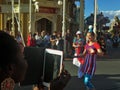 Disneyworld employee smiling during main street parade in the afternoon