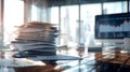 A disorganized stack of papers and folders rises sharply from a desk, surrounded by a contemporary office setting and Royalty Free Stock Photo
