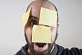 Disparate man with postit on his face