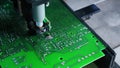 Dispencer machine used on surface of PCB printed circuit board in soldering process. Soldering paste. Assembling. Modern