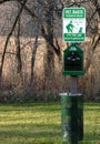 Dispenser stand with disposable bags and urn for cleaning the dog. Walking the dogs. Royalty Free Stock Photo