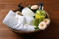 Dispensers of liquid soap, towel and roses in wicker basket on wooden table Royalty Free Stock Photo