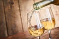 Dispensing golden white wine into two wineglasses Royalty Free Stock Photo