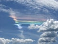 Dispersion of sun light rainbow in condensation trails, produced by aircraft engine exhaust.