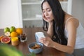 Serious young lady sitting at the table