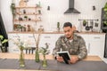 Dispirited serviceman staring at the photo in his hands