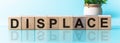 DISPLACE word written on wood block, blu background