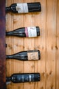 Display of Alentejo wine bottles on wall-mounted rack in a rustic restaurant.