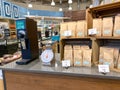 A display of Allegro coffee with a coffee grinder and scale of a Whole Foods Market Grocery Store