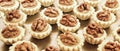 Display of assorted gluten free cupcakes with walnuts  sitting on display table Royalty Free Stock Photo