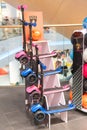 Display of assorted Lamborghini childrens scooters on a white stand with three shelves in a showroom or store setting, under Royalty Free Stock Photo