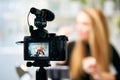 Display of camera recording video blog for blonde beauty blogger woman with make-up at home studio. Influencer vlogger Royalty Free Stock Photo