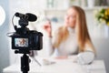 Display of camera recording video blog for blonde beauty blogger woman with make-up at home studio. Influencer vlogger