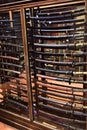 A display case contains two racks with dozens of samurai swords each, with their sheath, in a room of Villa Stibbert, in Florence.