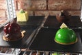 Display case with different delicious desserts on shelf in cafe, closeup
