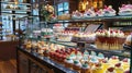 A display case in a restaurant showcasing a variety of different cakes, including chocolate, vanilla, lemon, and Royalty Free Stock Photo