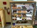 A display case of tasty donuts at a Wawa restaurant and gas station