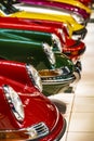 Display of colorful classic sports cars in an exhibit hall