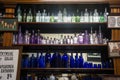 A display of colourful old medicine bottles