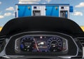 Display in the dashboard of an electric car indicating the need to recharge the battery and the ending range against the