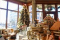 Display of dishes pillows etc in Pioneer Woman Mercantile in front of blurred Christmas tree and windows showing Pawhuska Osage Co