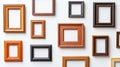Display of empty wooden frames in varying sizes and styles on a white wall in a modern setting Royalty Free Stock Photo