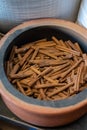A display of fresh cinnamon sticks in a bowl