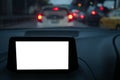 Display of GPS or navigator device in a holder in car with blur background of traffic jams in the evening. Mockup white empty Royalty Free Stock Photo