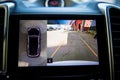 Display in interior of luxury car shows working of four cameras in surround view Parking assist system. 360 degrees Image display