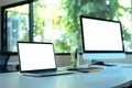 Display laptop and desktop computer with office tools on desk. display screen clipping path Royalty Free Stock Photo