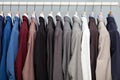 Display of man suits in a closet Royalty Free Stock Photo