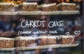 Display at a market stall with cakes behind glass