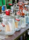 A display of old antique glass butter churns