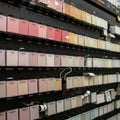 A display of paint color samples arranged on a pegboard wall at a store. The samples Royalty Free Stock Photo
