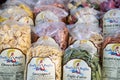 Display of plastic bags with colorful pasta in small grocery shop in historic old town street in Alberobello, Italy