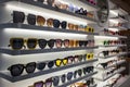 Display rack full of sunglasses. Fashionable sunglasses on the shop shelf Royalty Free Stock Photo