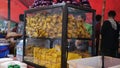 Display racks sell fried chicken, tempeh and tofu in Nasi Uduk street food tents.