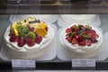 Display of replica fruit pastry in front of a bakery