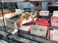 A display of a variety of fish in a refrigerated case at a grocery store