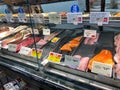 A display of a variety of fish in a refrigerated case at a grocery store