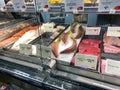 A display of a variety of fish in a refrigerated case at a grocery store