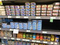 A display of various cans of tuna and salmon in the canned foods department of a Whole Foods Market Grocery Store Royalty Free Stock Photo