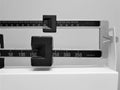 Black and white vintage doctors weight scale with two masses in pounds Royalty Free Stock Photo